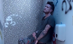 Tattooed guy fucks teen in pen up restroom