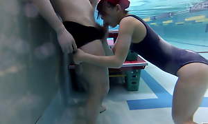 Japanese schoolgirls give swim coach submerged blowjob